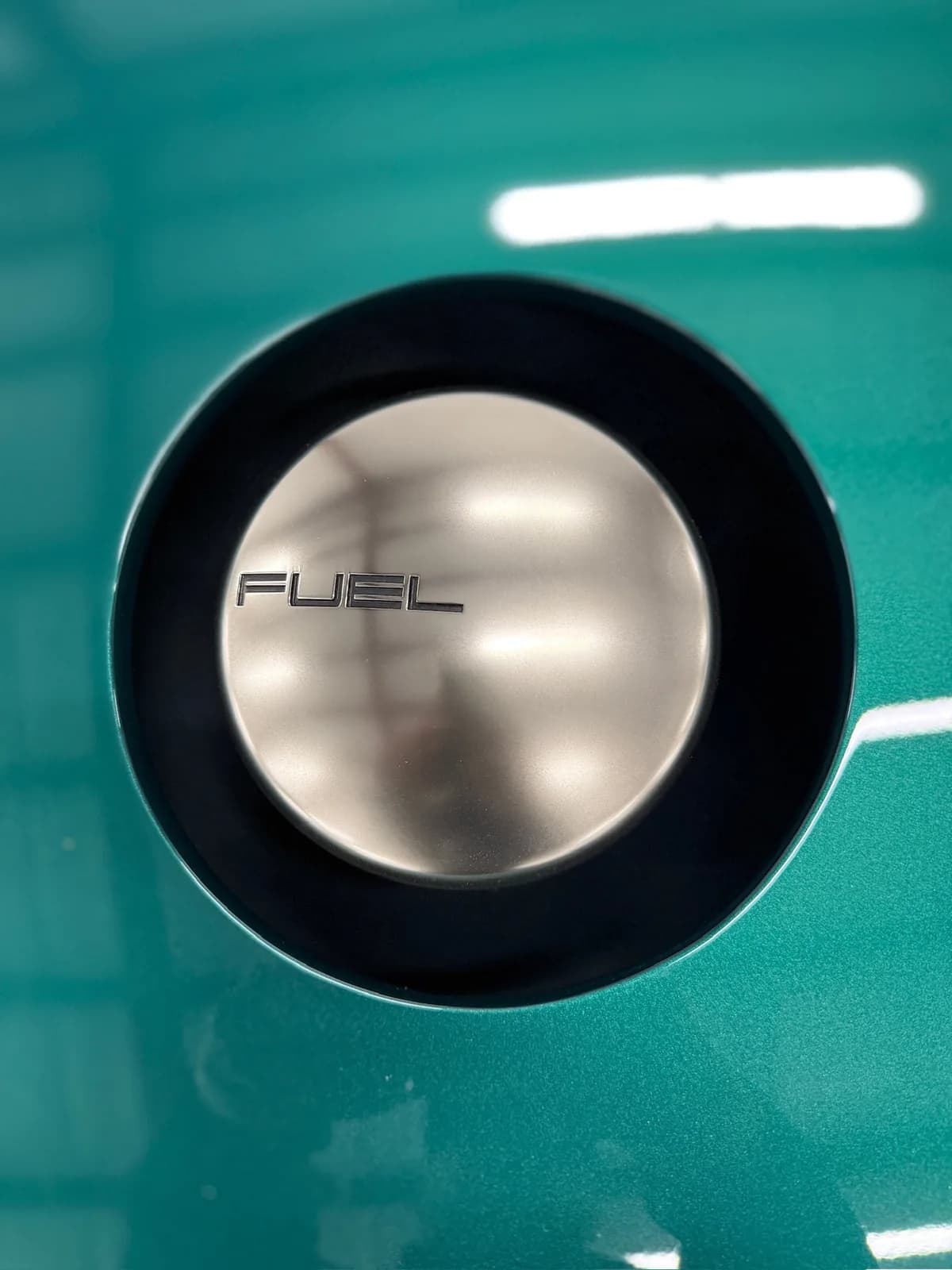 The center-fill fuel cap, machined billet, set into the rear deck
