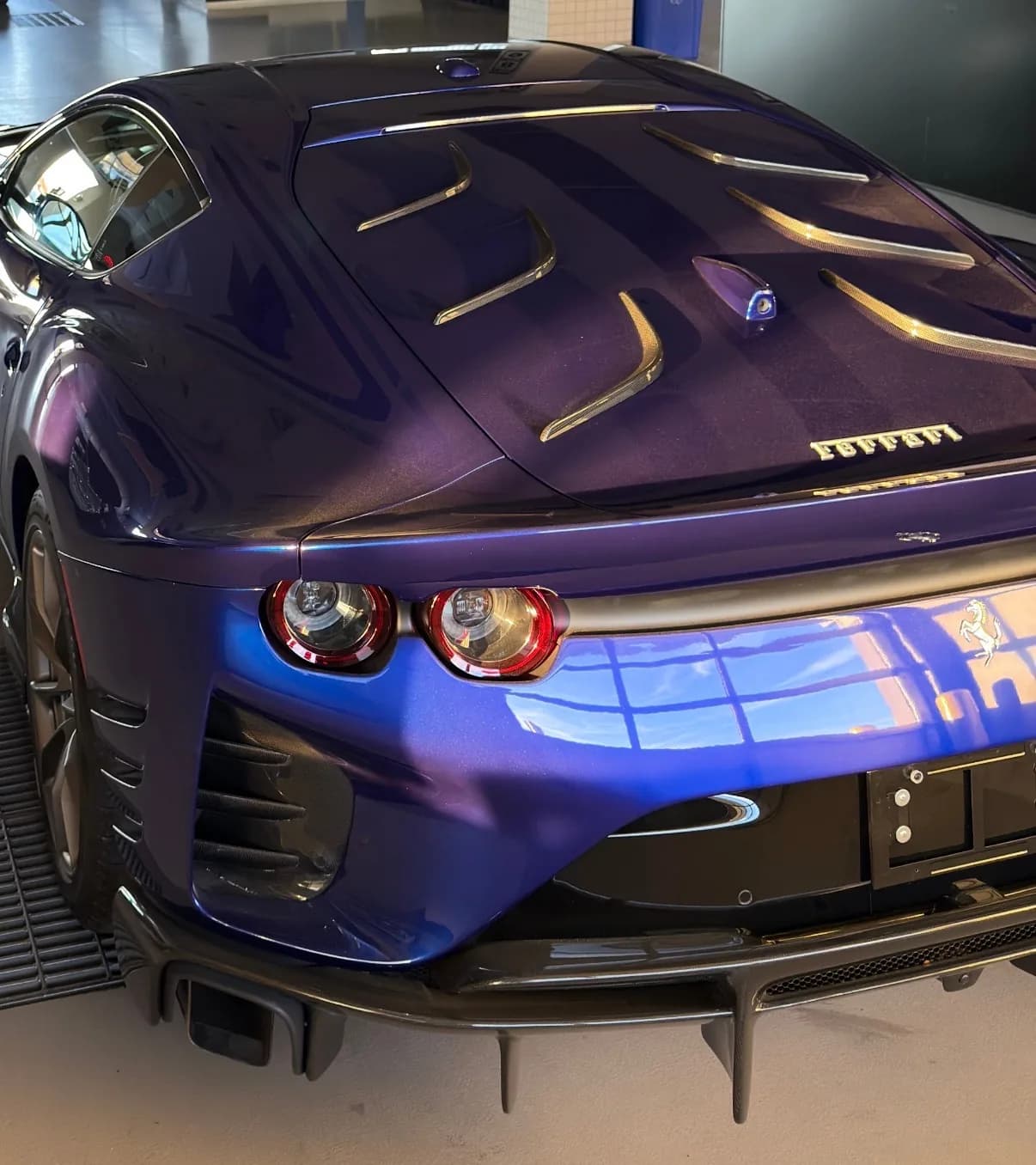 The vented aluminium rear panel that replaces the glass, seen from above in showroom light