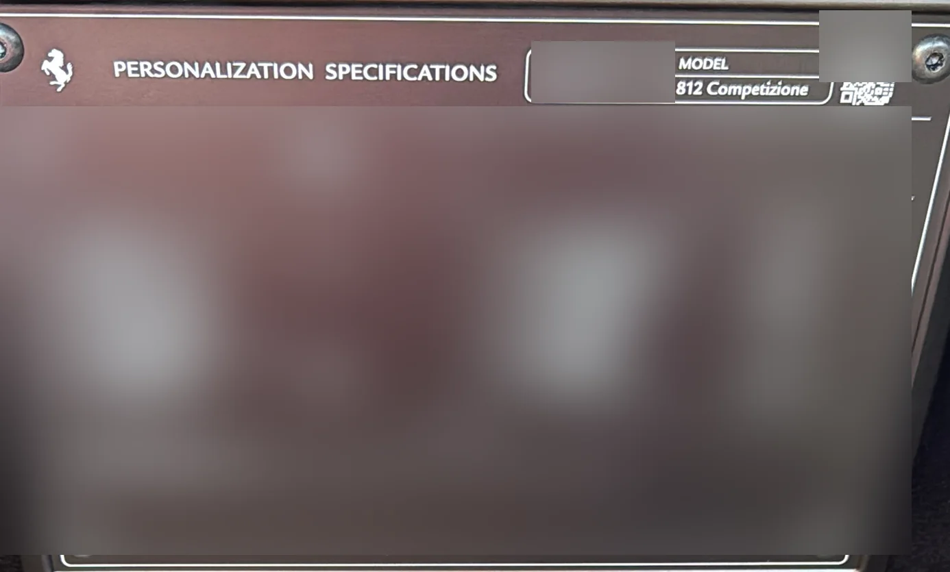 The Atelier personalization plate, model name and header legible, serial number and configuration blurred