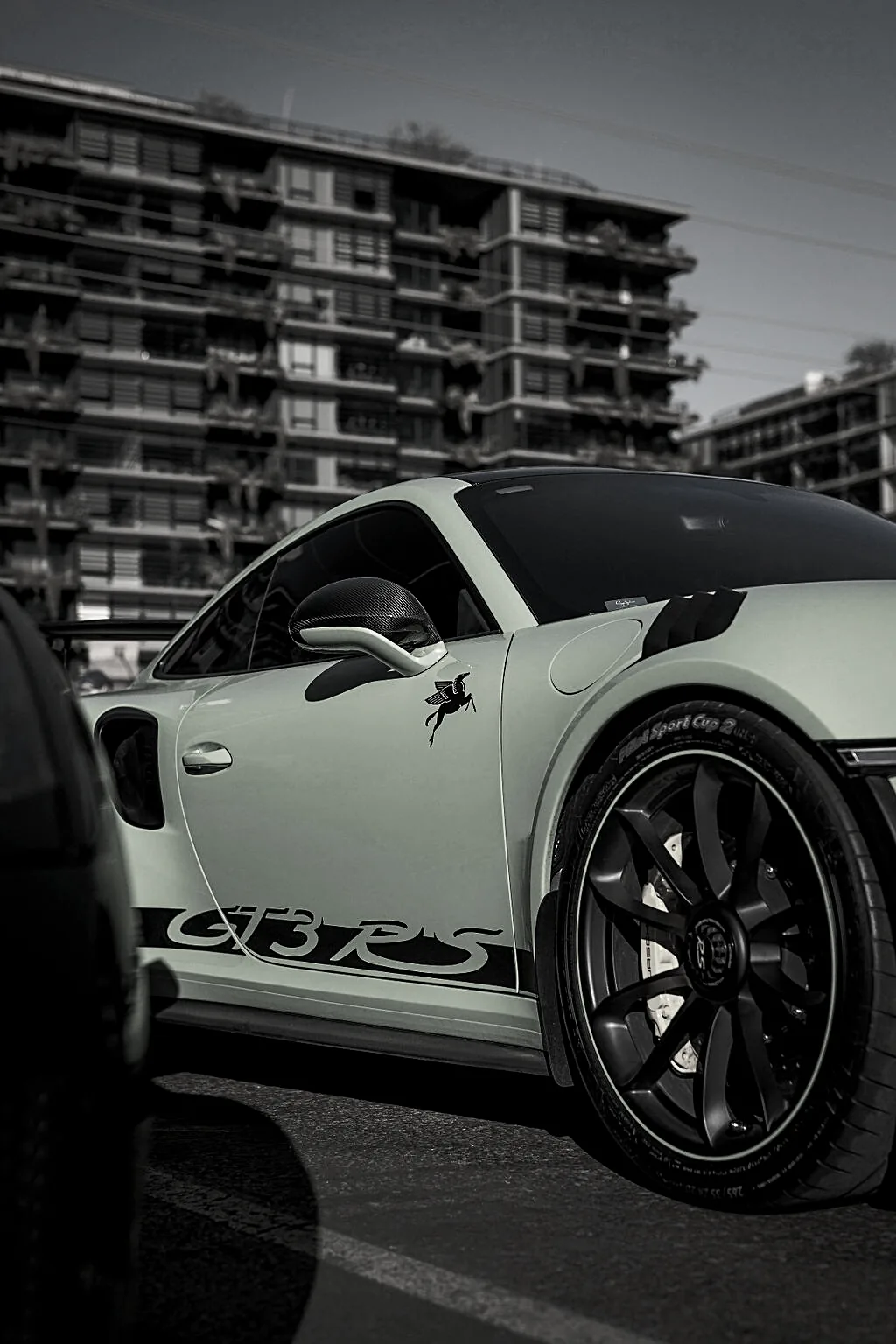 A Porsche 911 Turbo S parked in the row